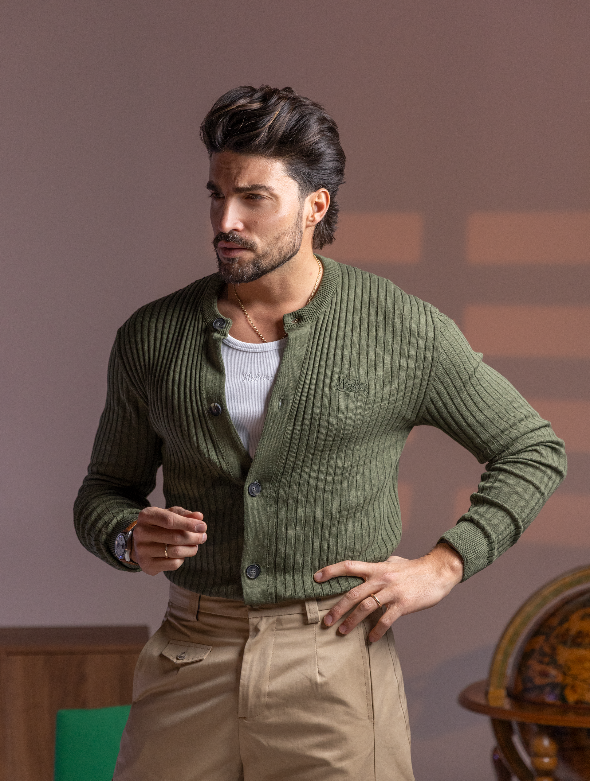 Man wearing green ribbed cardigan with embroidery